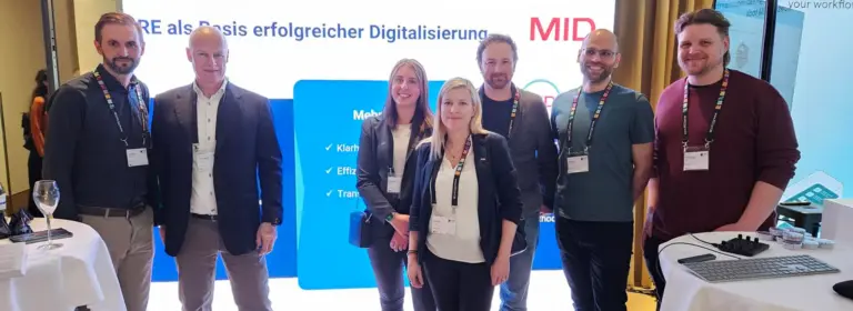 REConf 2026 | Team der MID GmbH am Messestand auf der REConf® 2026 in München mit Vorträgen zu KI und Traceability im Requirements Engineering | MID GmbH